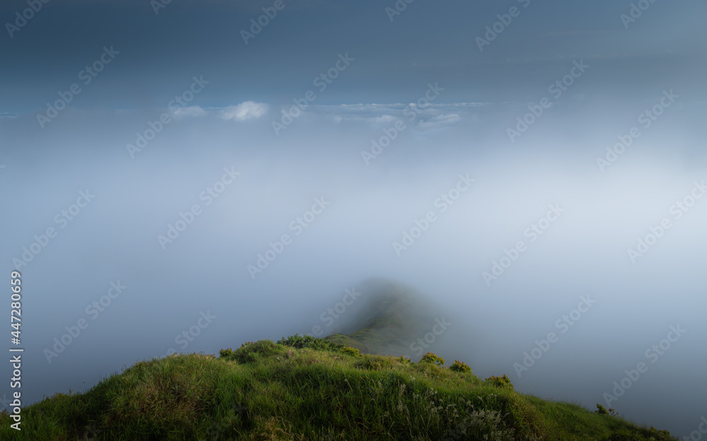 Clouds and fog quickly moving over Pico da Vara, highest point of Sao Miguel (Azores) on a summer afternoon