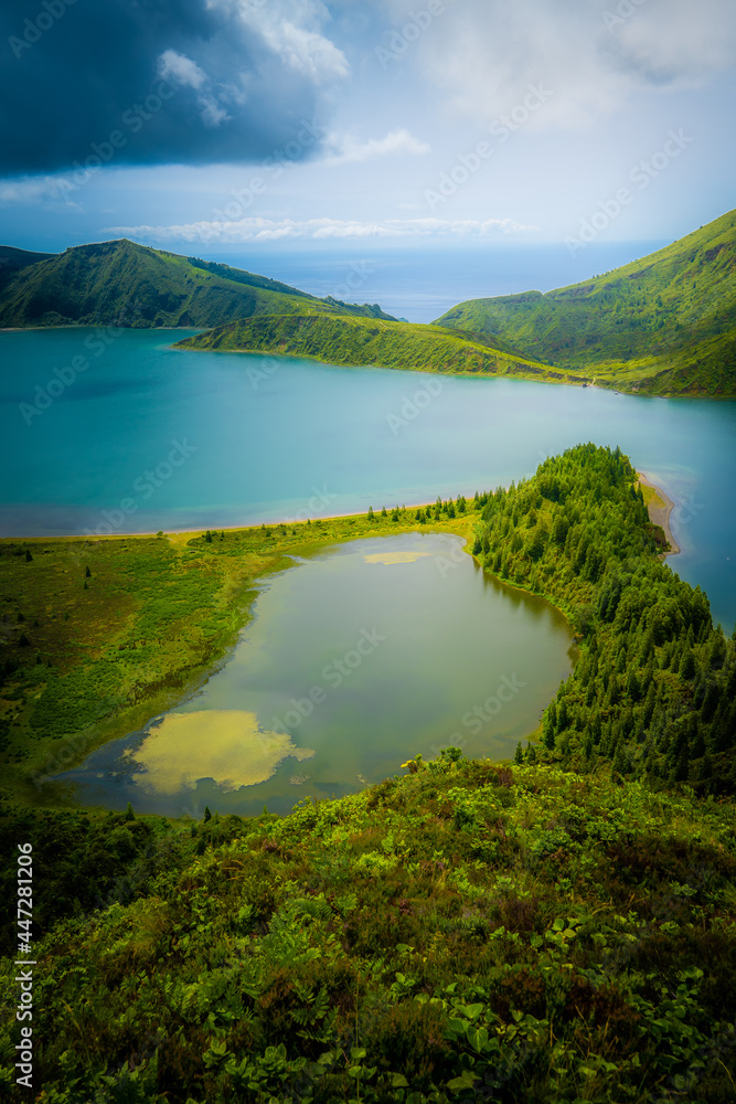 Lagoa do Fogo surrounded by forests in a bright summer afternoon
