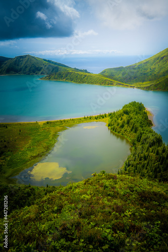 Lagoa do Fogo surrounded by forests in a bright summer afternoon