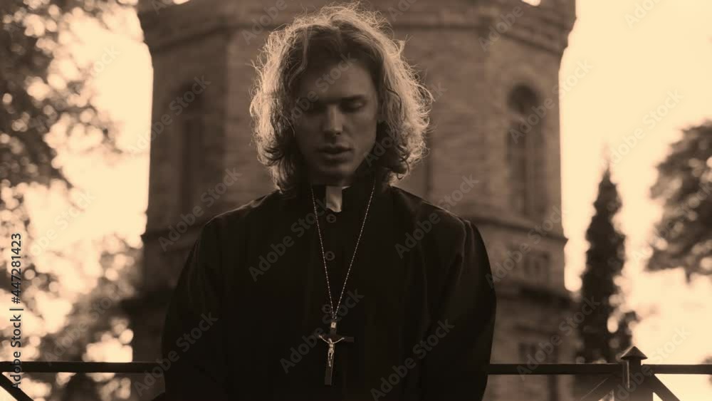 Christian priest with cross praying by the church. Christian priest with cross praying by the church.