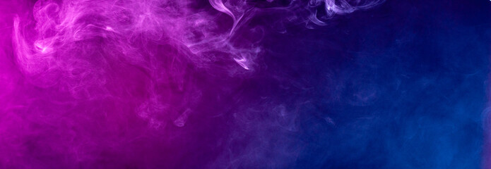 Abstract colorful smoke on black background .
