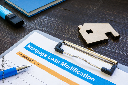 Mortgage loan modification application with pen and notepad.