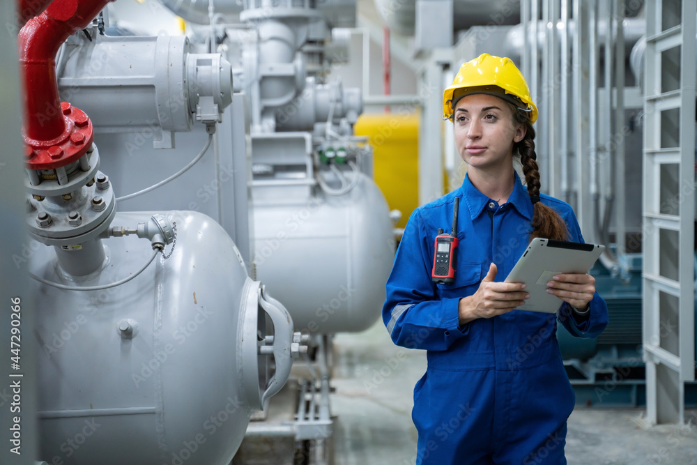attractive young engineer woman and working engineering in industry.Portrait of young female worker in the factory.Work at the Heavy Industry Manufacturing Facility concept. attractive young engineer woman and working engineering in industry.Portrait of young female worker in the factory.Work at the Heavy Industry Manufacturing Facility concept.