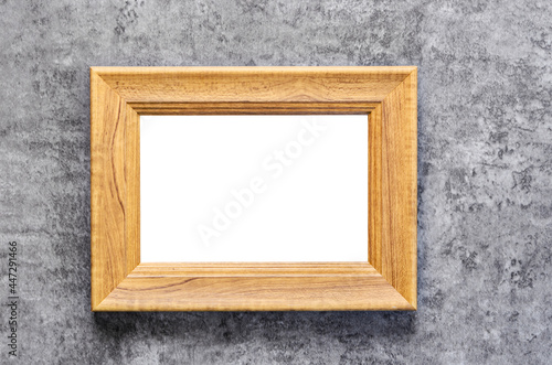 Blank wooden photo frame on grunge background.