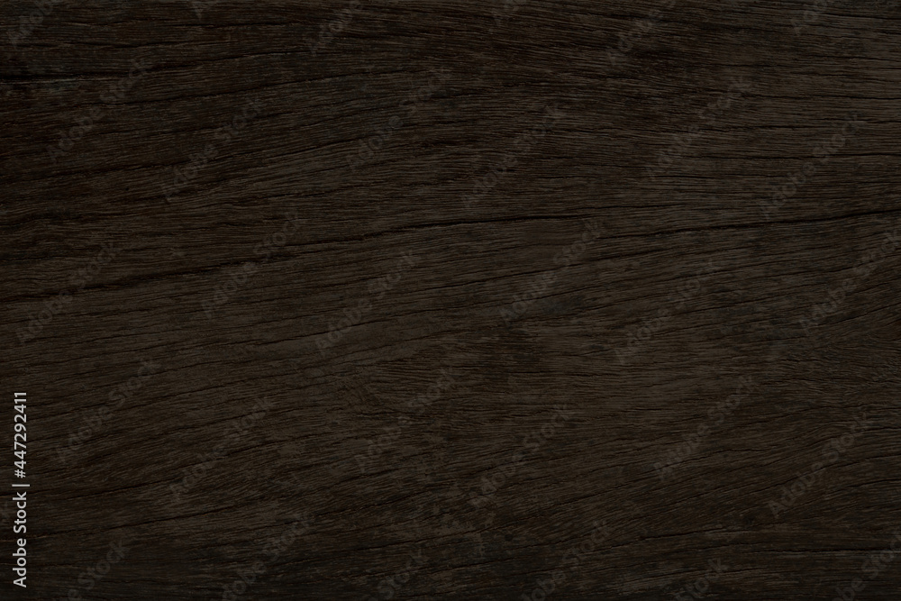 Dark brown wood with a rough surface for texture and background Dark brown wood with a rough surface for texture and background
