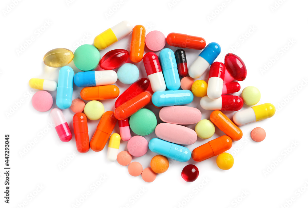 Pile of different colorful pills on white background, above view Pile of different colorful pills on white background, above view