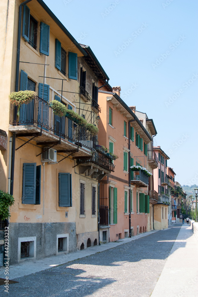Portrait format view of a small Italian town showing pastoral buildings shutters and balconies
