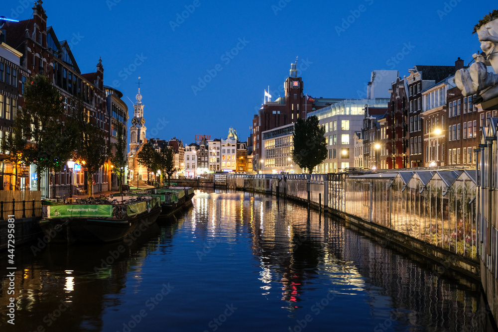 Sunset in the City of Amsterdam with colorfull reflections on the water, Amsterdam, Netherlands, Europe