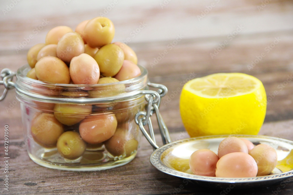 green salted canned olives in a glass jar