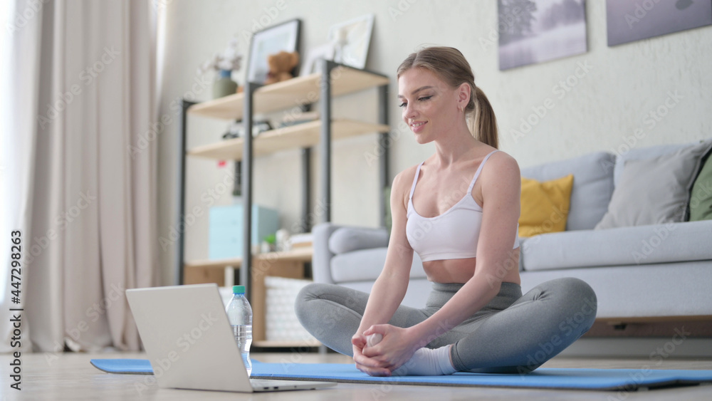 Woman doing Exercise during Video Chat on Laptop Woman doing Exercise during Video Chat on Laptop
