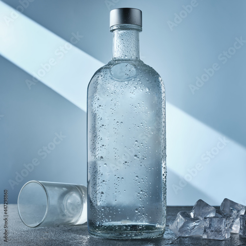 Obraz na płótnie A bottle of vodka and ice on the table