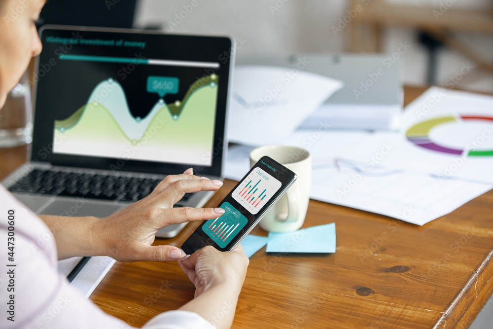 Young woman, manager working at office. Using laptop, modern gadgets. Remote working. Workplace at comapny, home with PC, devices. Young woman, manager working at office. Using laptop, modern gadgets. Remote working. Workplace at comapny, home with PC, devices.