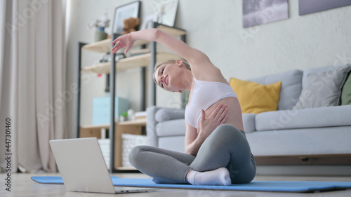 Woman doing Yoga While on Video Call on Laptop