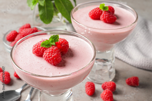 Delicious raspberry mousse with mint on light grey table