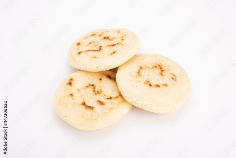 Stack of arepas made with corn flour on a white background, typical Latin American food. They are generally eaten in countries such as Venezuela