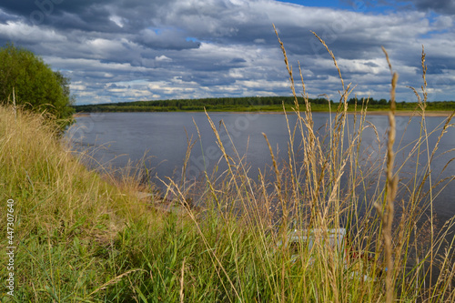 On the river bank. Clouds in the sky above the river. Komi Republic.