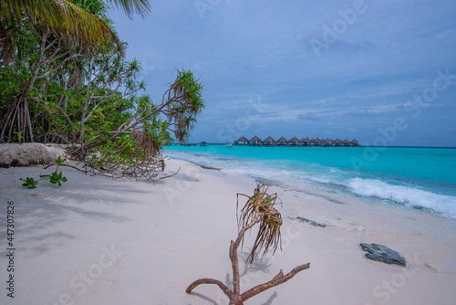 Scenic view of the Thulhagiri Island Resort in the Maldives surrounded by the ocean photo
