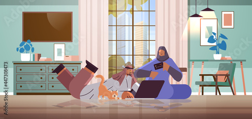 arab couple with credit card using laptop online shopping concept man woman ordering goods together
