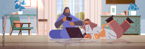 arab couple with credit card using laptop online shopping concept man woman ordering goods together