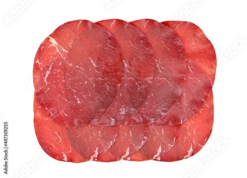 Slices of Bresaola, traditional  air dried salted beef cold meat from North Italy, on white background.  photo