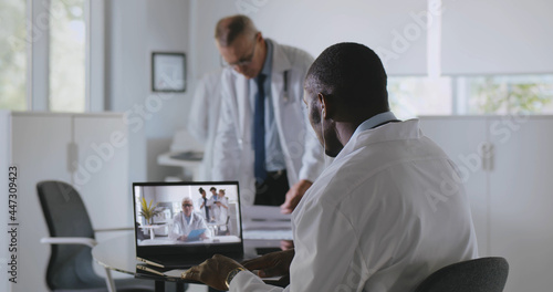 Wallpaper Mural Afro-american male practitioner consulting colleague online on video call Torontodigital.ca