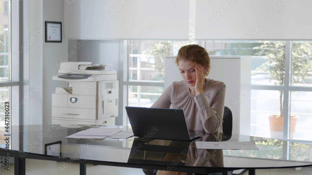 Tired caucasian female office employee in workplace Tired caucasian female office employee in workplace