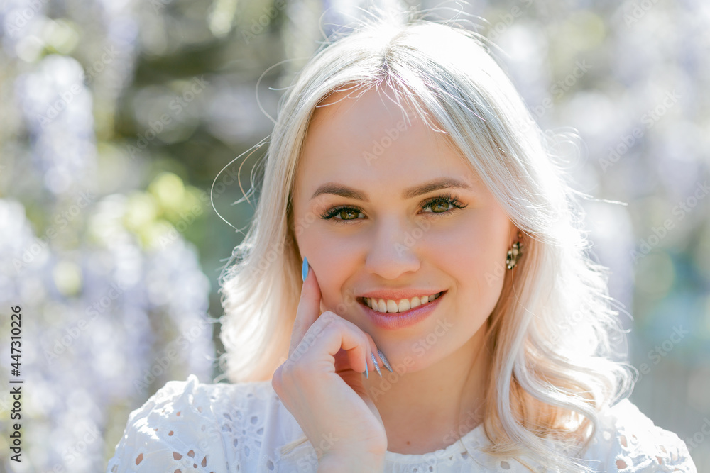 Portrait of a young beautiful woman in a blooming garden. Spring. Wisteria. Portrait of a young beautiful woman in a blooming garden. Spring. Wisteria.