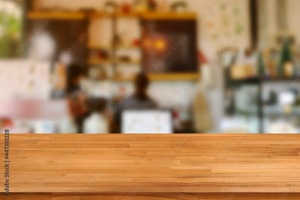 Wood table on blurred cafe shop background Wood table on blurred cafe shop background