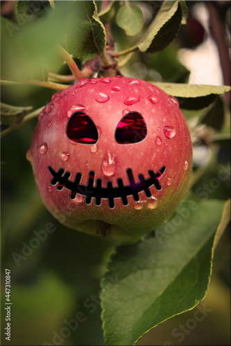 Halloween red  apple. Apple with scary glowing eyes. Helovin holiday. photo