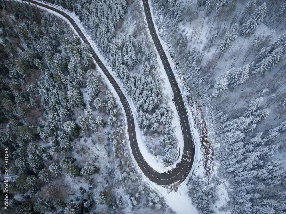winding road aerial with snow in La panche des belles filles Vosges region France