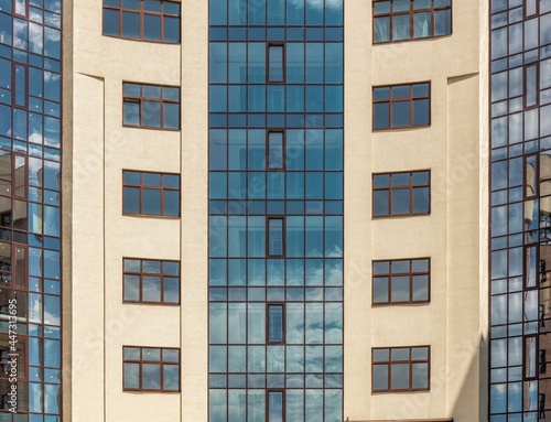 Facade windows of modern multi-storey brown beige building in the city. Space for text. High quality photo