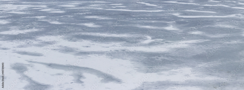 Texture of snow-covered ice on the river after a blizzard. Winter background