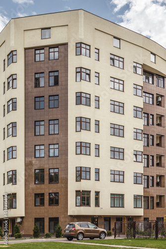 Facade of modern multi-storey brown beige building in the city. Space for text. High quality photo © Kirill