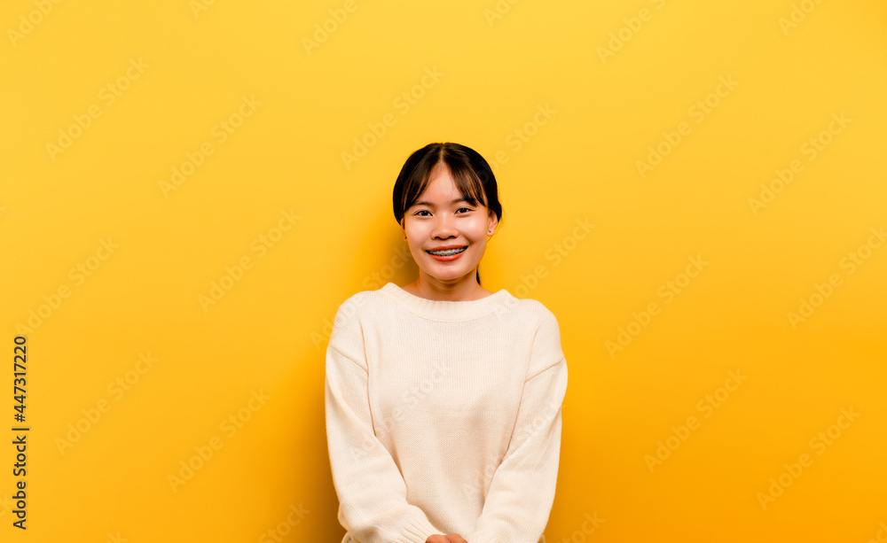 asian girl Beautiful wearing a white casual dress on a yellow background. Celebrate the victory with a happy smile and the winner's expression with a raised hand. happy expression asian girl Beautiful wearing a white casual dress on a yellow background. Celebrate the victory with a happy smile and the winner's expression with a raised hand. happy expression