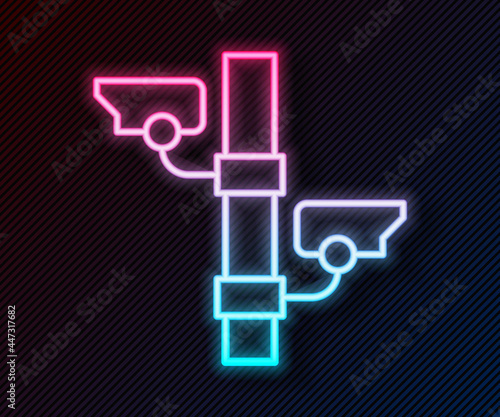 Glowing neon line Security camera icon isolated on black background. Vector