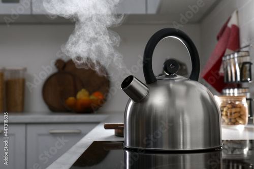 Steaming kettle on electric stove in kitchen