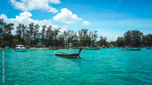Local boats of southern Thailand floating in the sea clear skies, sandy beaches