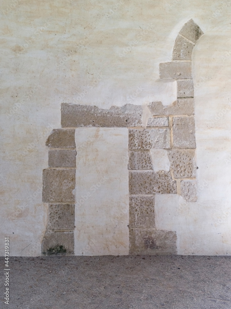 Medieval wall with window and door remains
