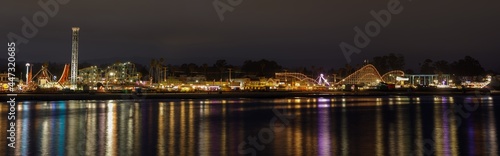 Panoramic views of Santa Cruz Beach Boardwalk Amusement Park with night reflections. Santa Cruz, California, USA.