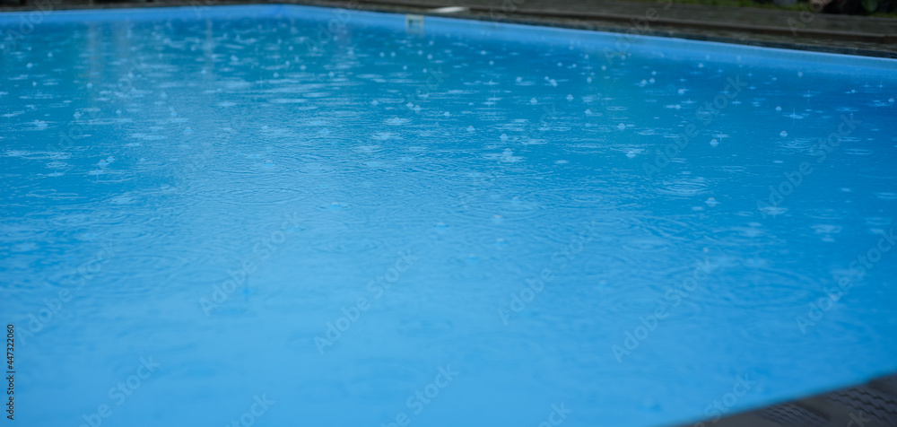 Swimming pool with raindrops. Autumn season