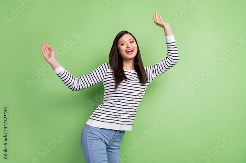 Photo of funny brunette young lady dance wear white shirt isolated on green color background