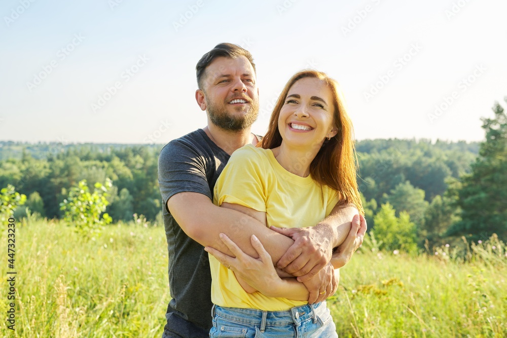 Portrait of happy adult couple on summer sunny day