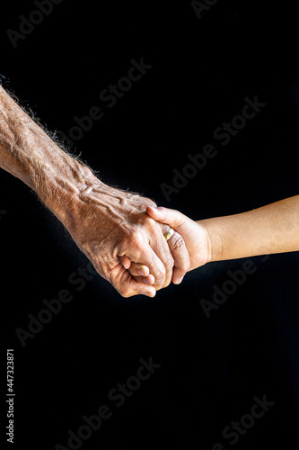 Old and young hold hands