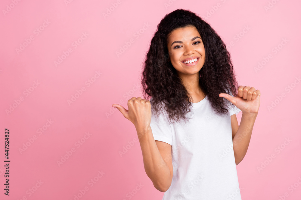 Photo of optimistic wavy hairdo young lady point empty space wear white t-shirt isolated on pastel pink color background Photo of optimistic wavy hairdo young lady point empty space wear white t-shirt isolated on pastel pink color background