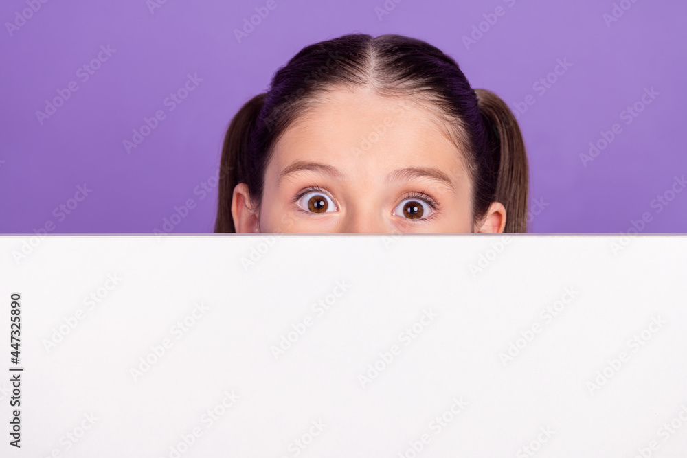 Photo of sweet impressed school girl wear blue uniform white billboard cover face empty space isolated purple color background Photo of sweet impressed school girl wear blue uniform white billboard cover face empty space isolated purple color background