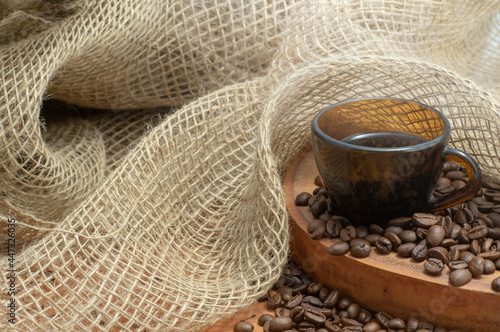 brown coffee cup and coffee beans on rustic background. copy space
