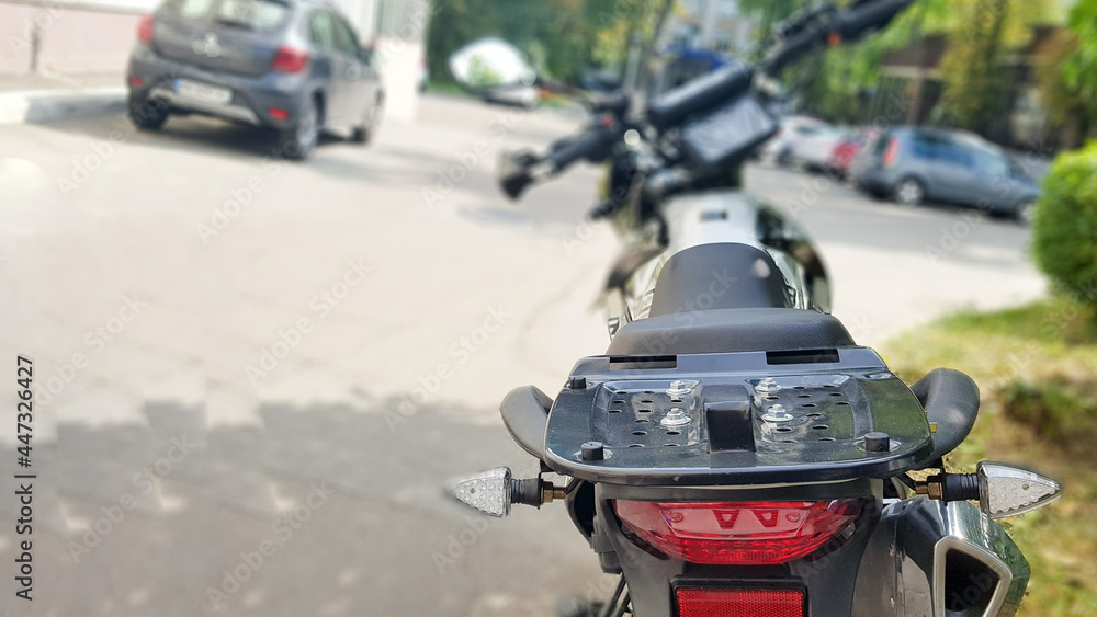 Black motorcycle parked. Back view. Soft focus Black motorcycle parked. Back view. Soft focus
