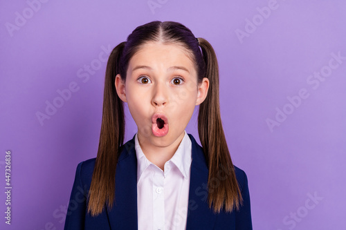 Obraz na plátne Photo of impressed shocked schoolgirl dressed blue uniform big eyes isolated vio
