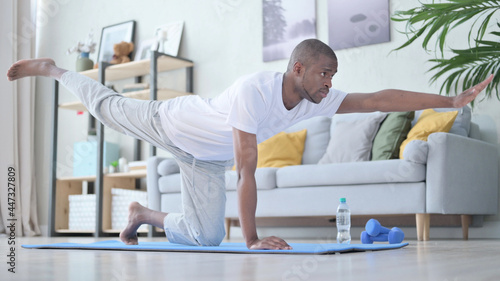 Workout on Yoga Mat at Home by African Man