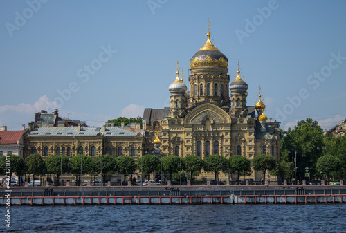 beautiful Church of the Assumption of the Blessed Virgin Mary on the Lieutenant Schmidt embankment near the Neva River on a sunny clear summer day and a copy space in Saint-Petersburg